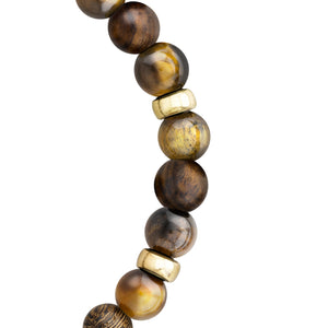 Detalle de las cuentas marrones y doradas de la pulsera, con separadores metálicos dorados entre algunas de las cuentas.