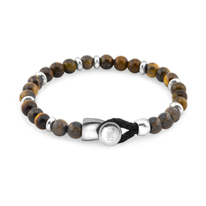 Pulsera de cuentas marrones con separadores de metal plateado y un cierre de hebilla en plata con un lazo de cordón negro.