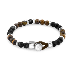 Pulsera de cuentas en tonos marrón, gris y negro, con separadores plateados y un cierre de hebilla plateado, asegurado con un lazo de cordón marrón.
